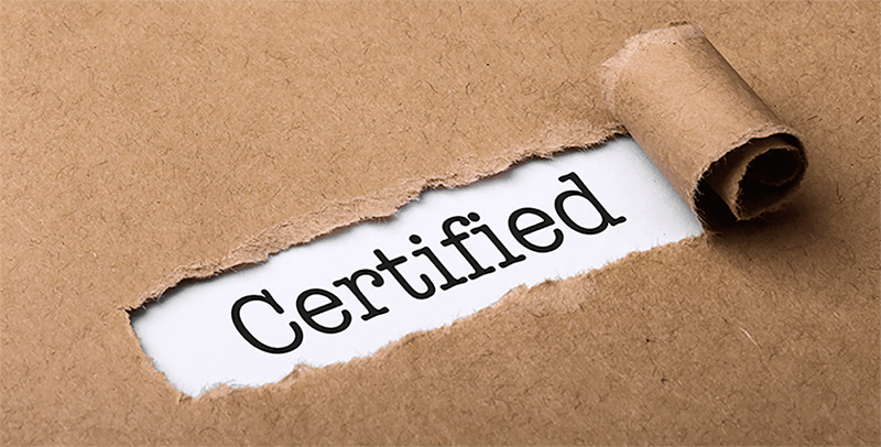 the word certified revealed by hole in cardboard
